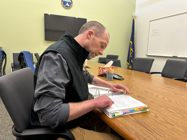 Man reviews text in binder