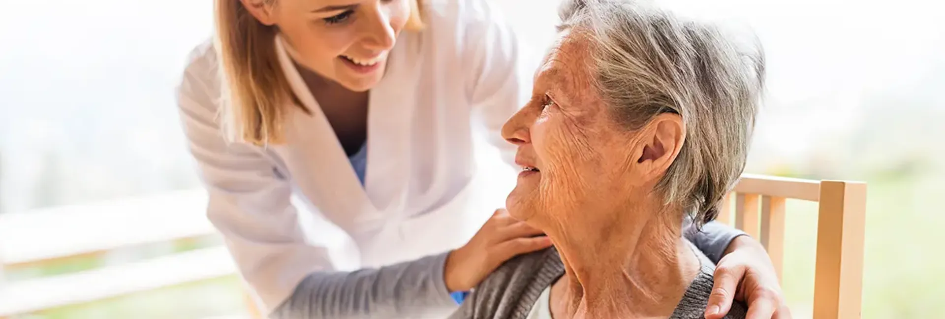 Health care worker comforting elder