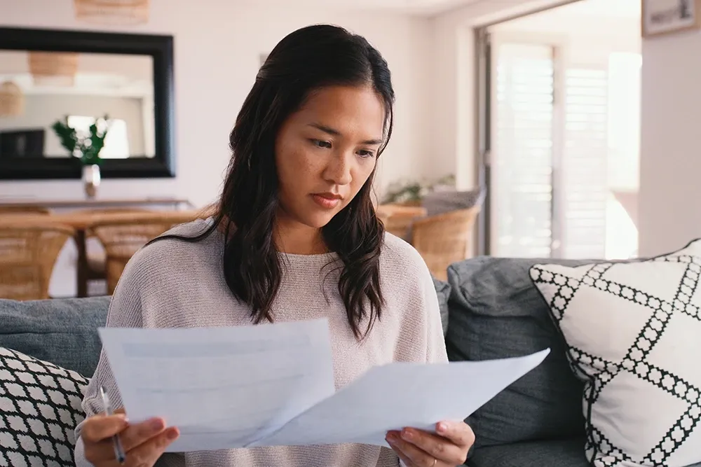 Asian woman looking at paperwork