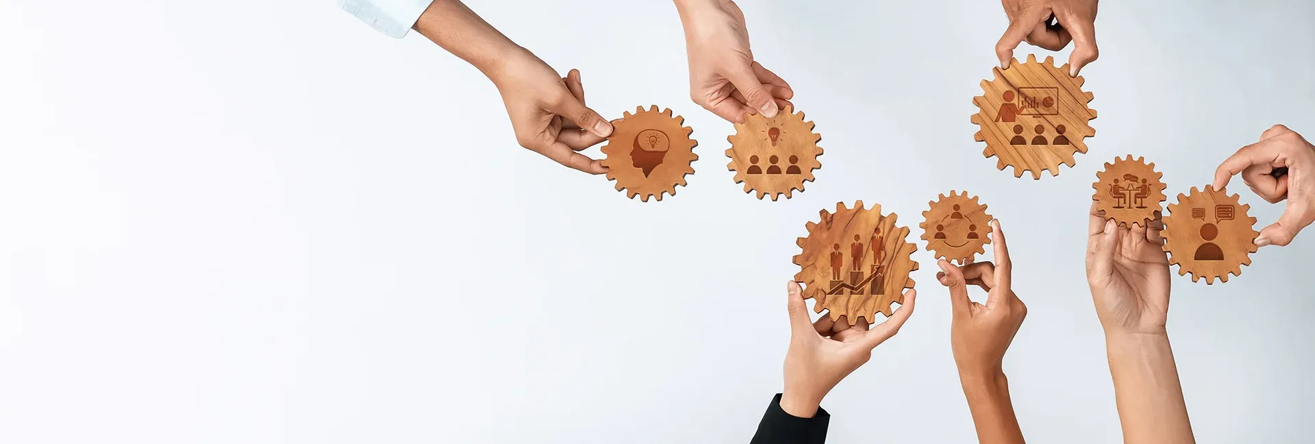 Hands holding wooden gears with productivity icons