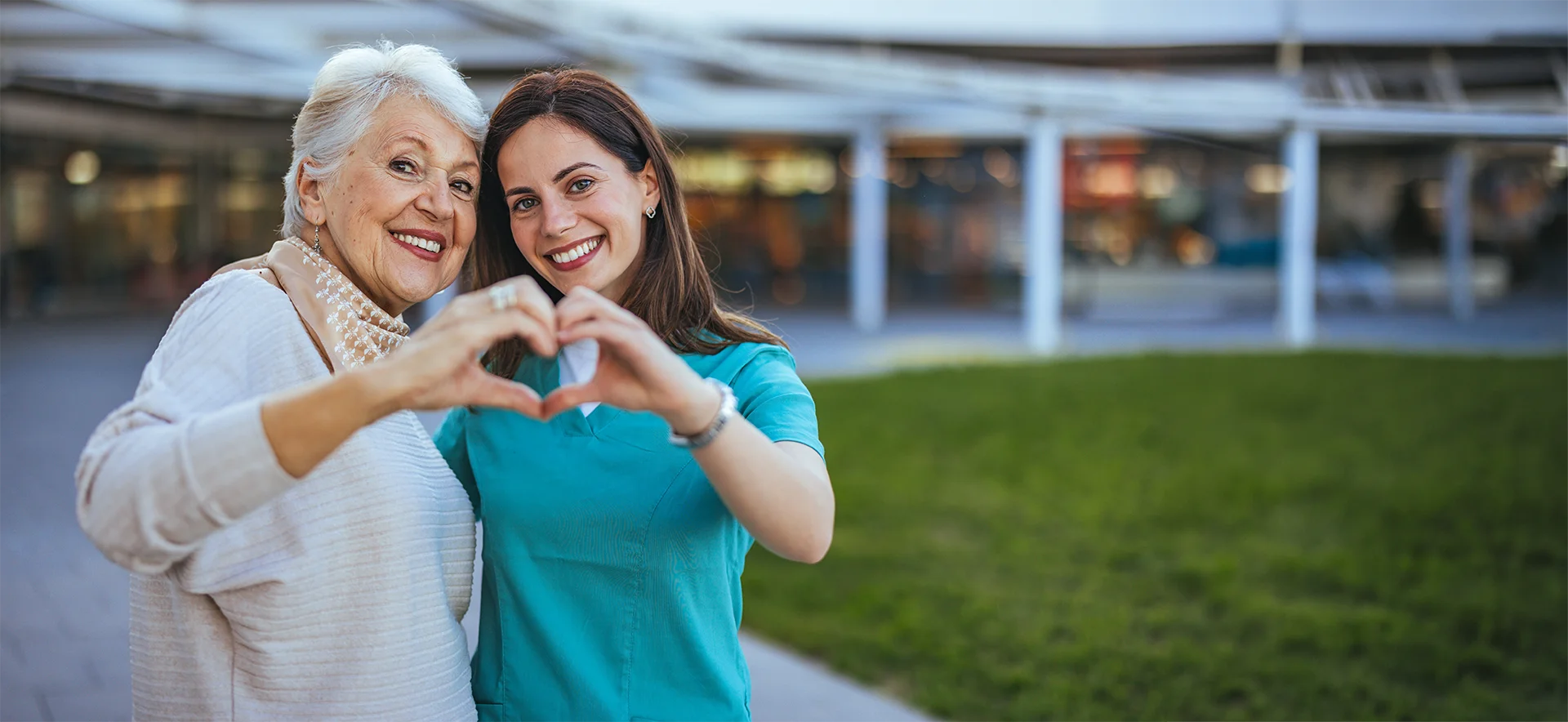 Two women forming a heart with their hands
