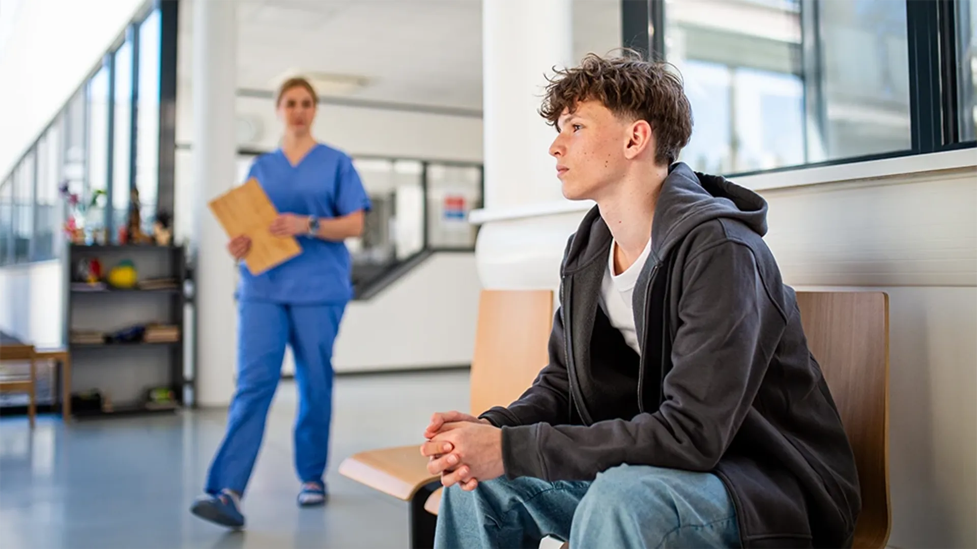 Nurse approaching waiting teenager