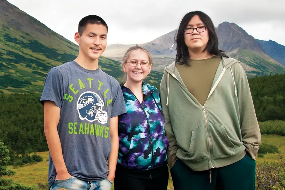 Three Alaskan teens on a mountain