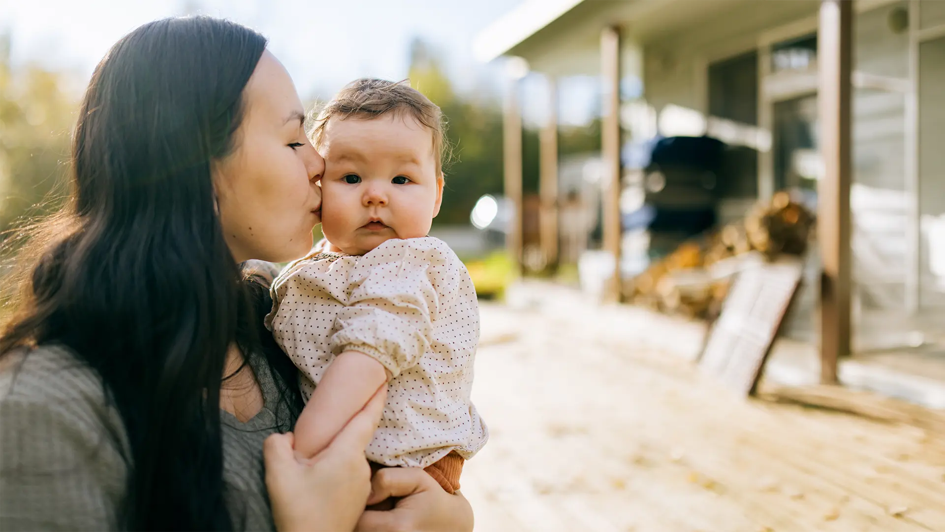 Mother Embracing Her Cute Baby at Alaskan Home