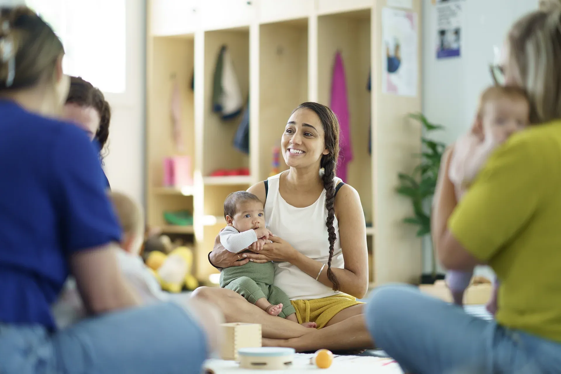 Woman with a baby on her lap in a parenting class