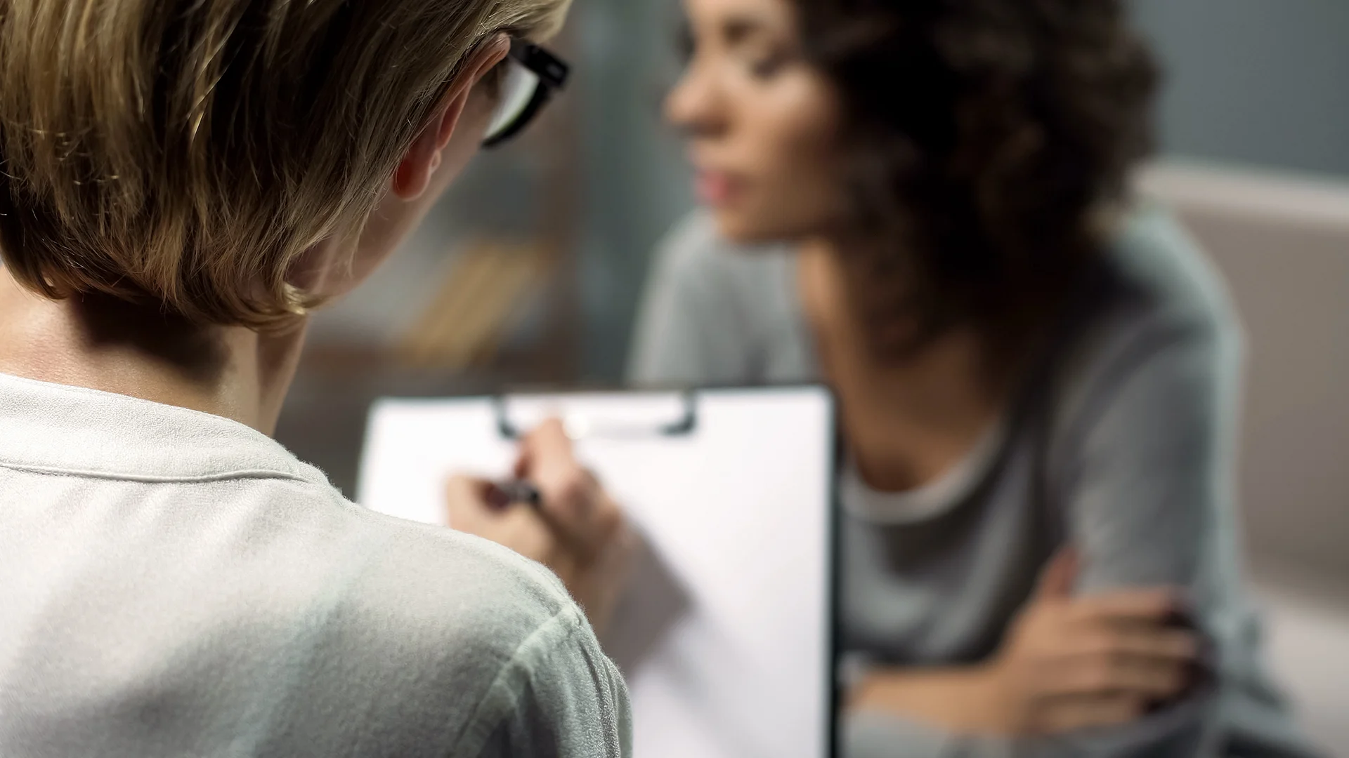 Sad woman speaking with psychotherapist