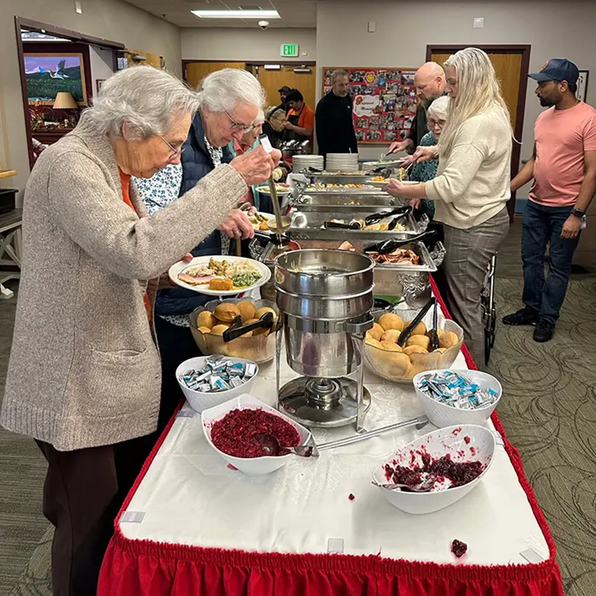 Food line with table loaded with food for Thanksgiving