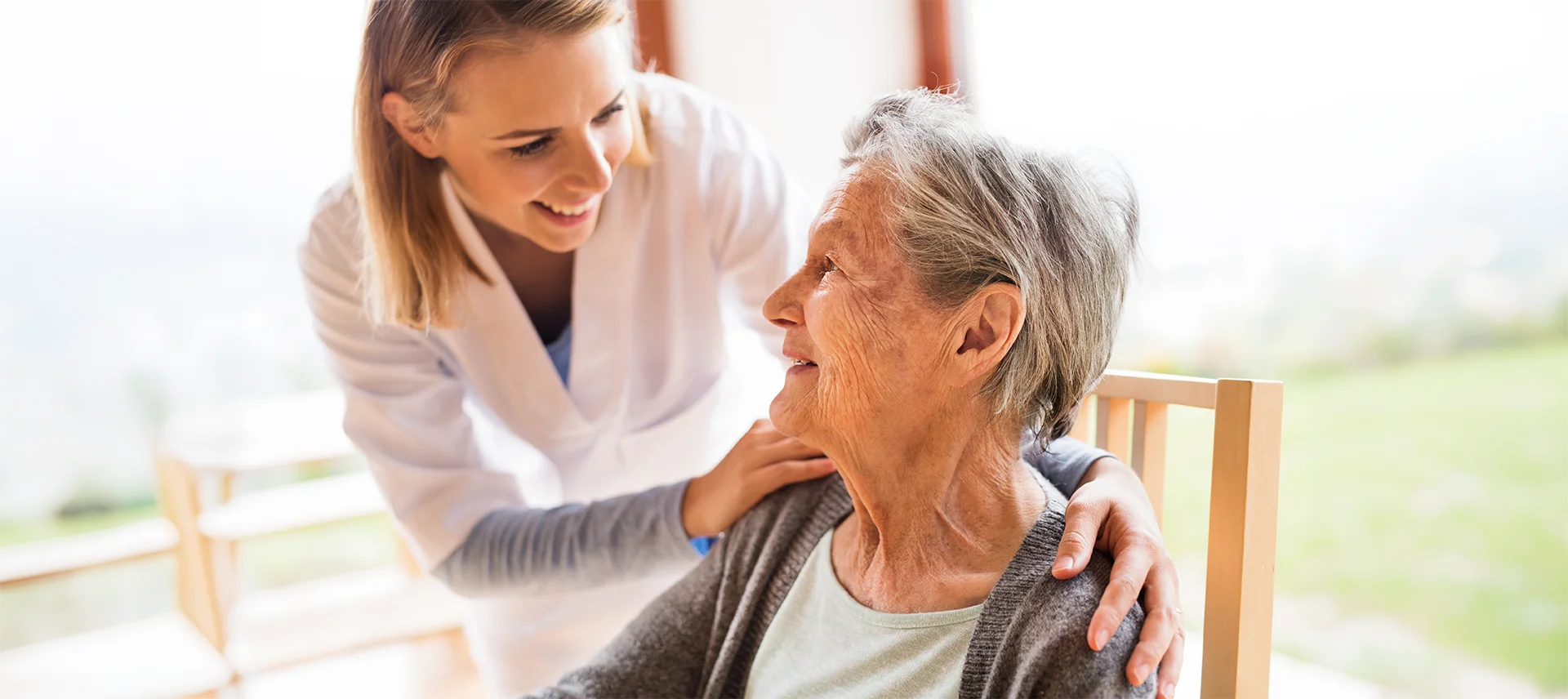 Health care worker comforting elder