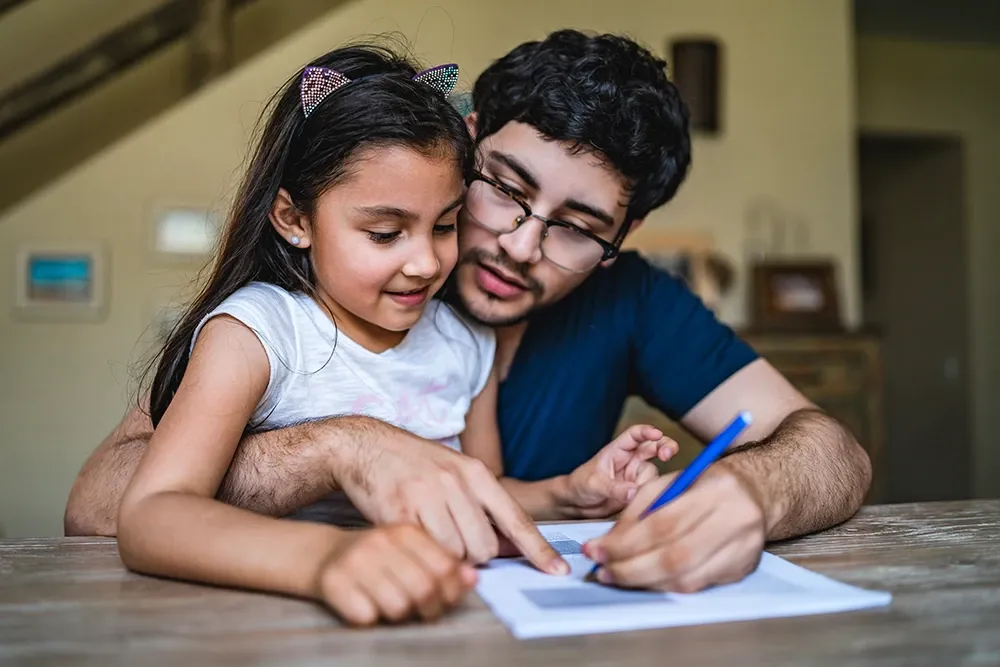 Adult man filling out a form with his daughter