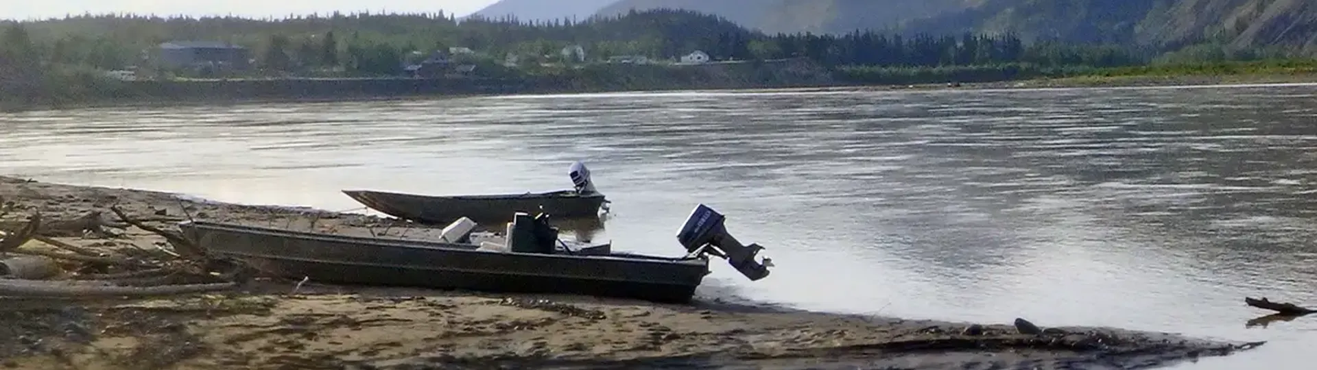 Skiffs pulled out of water, across from a mountain. Photo courtesy Lindsay Bothe Culverhouse.