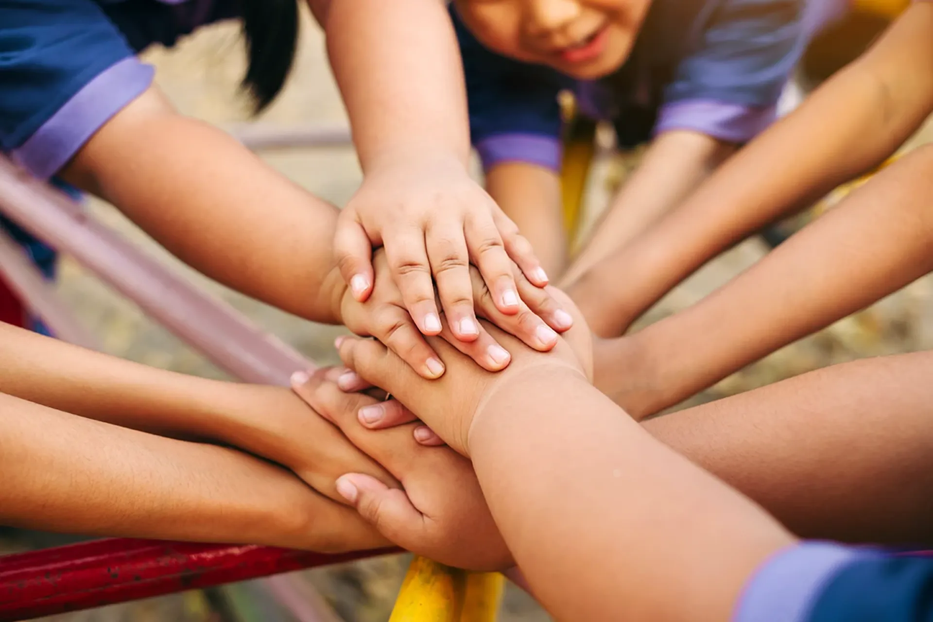 Group of diverse kids, hands of together for teamwork, community, togetherness and collaboration.