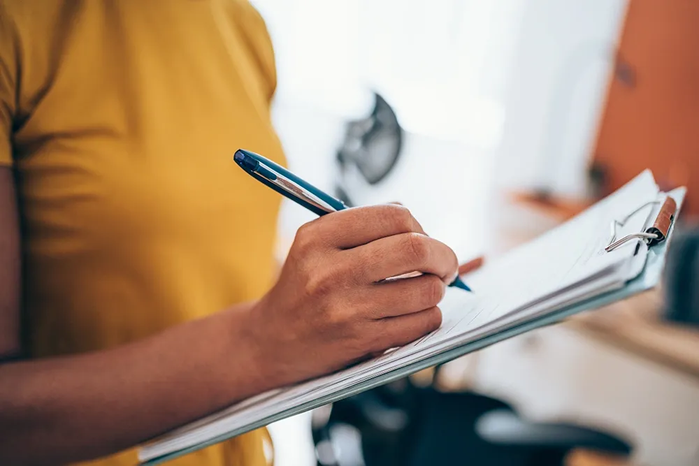 Closeup on woman signing document