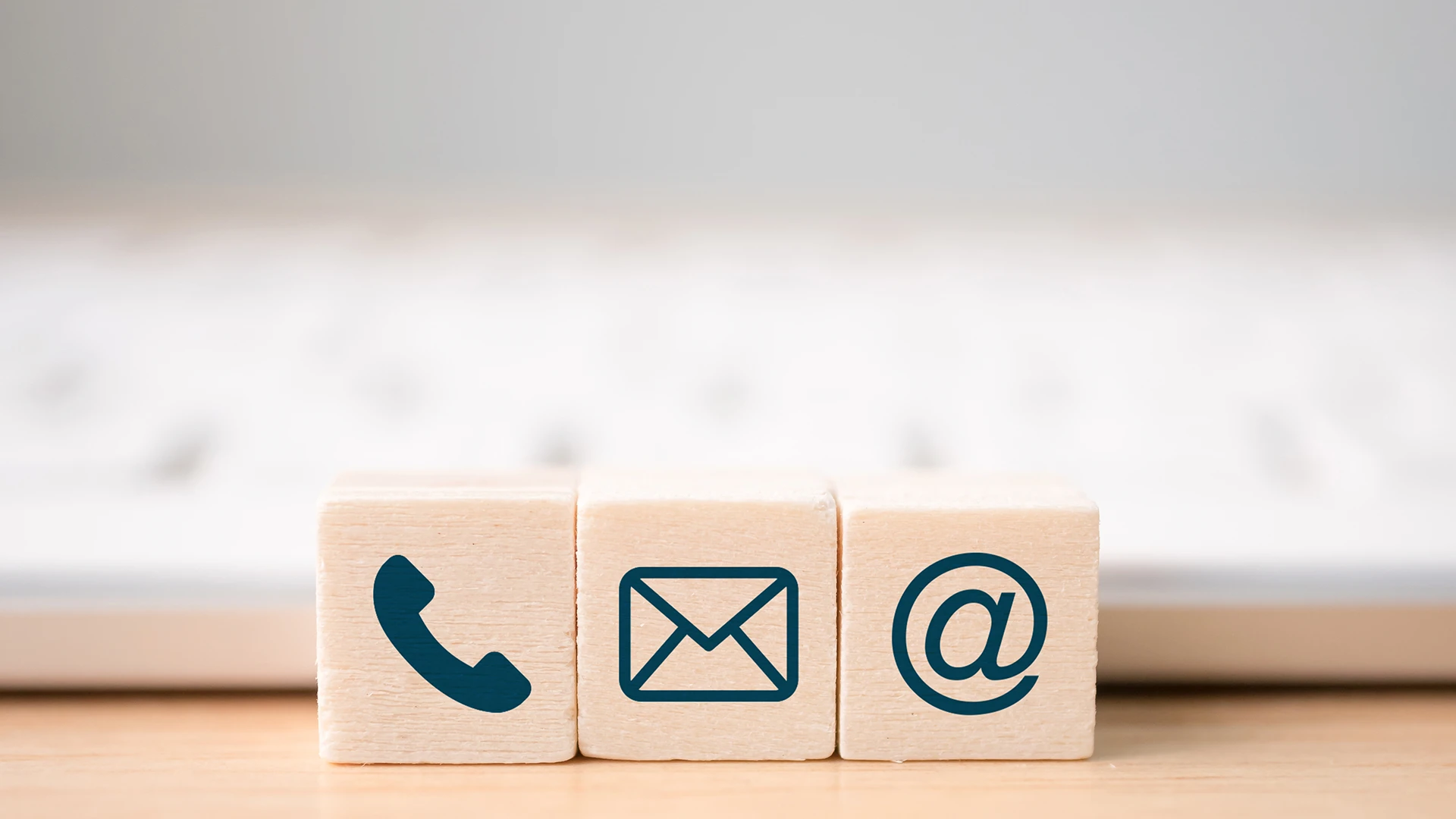 Stacking blocks with phone, envelope, @-sign icons
