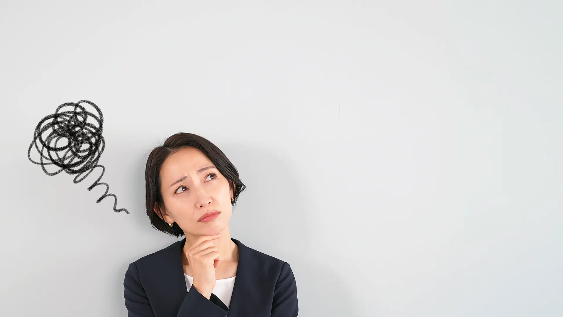 Woman thinking, squiggles drawn behind her