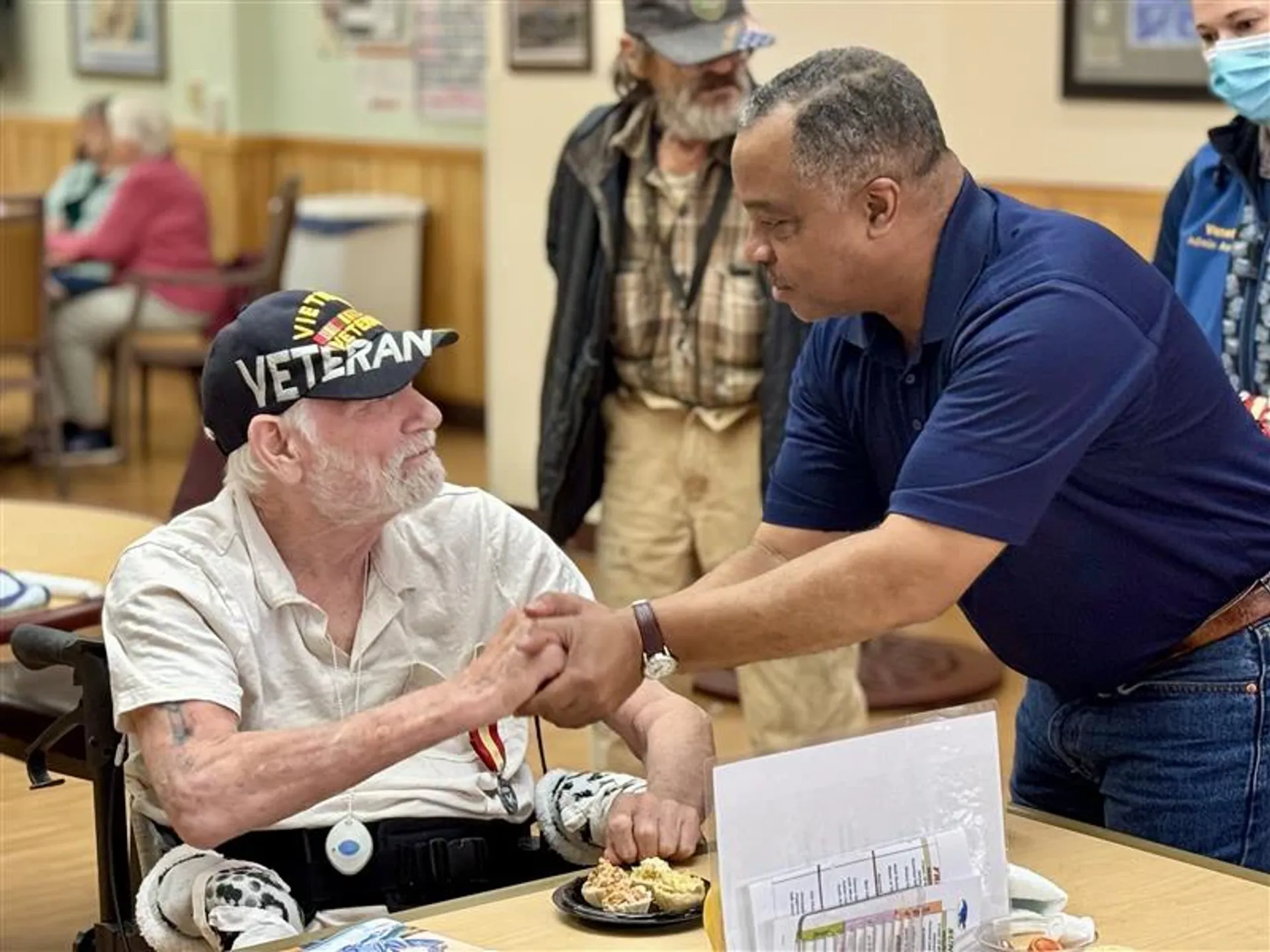 Handshake with a veteran at the Alaska Veterans and Pioneers Home