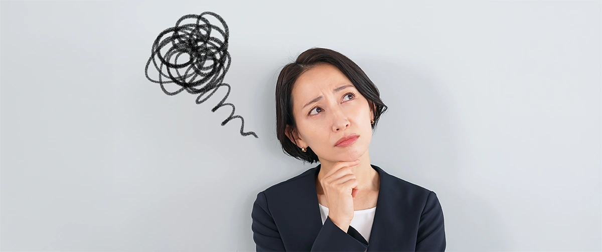 Woman thinking, squiggles drawn behind her