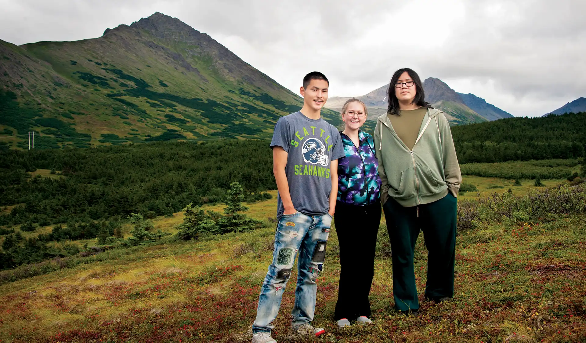 Three Alaskan teens on a mountain