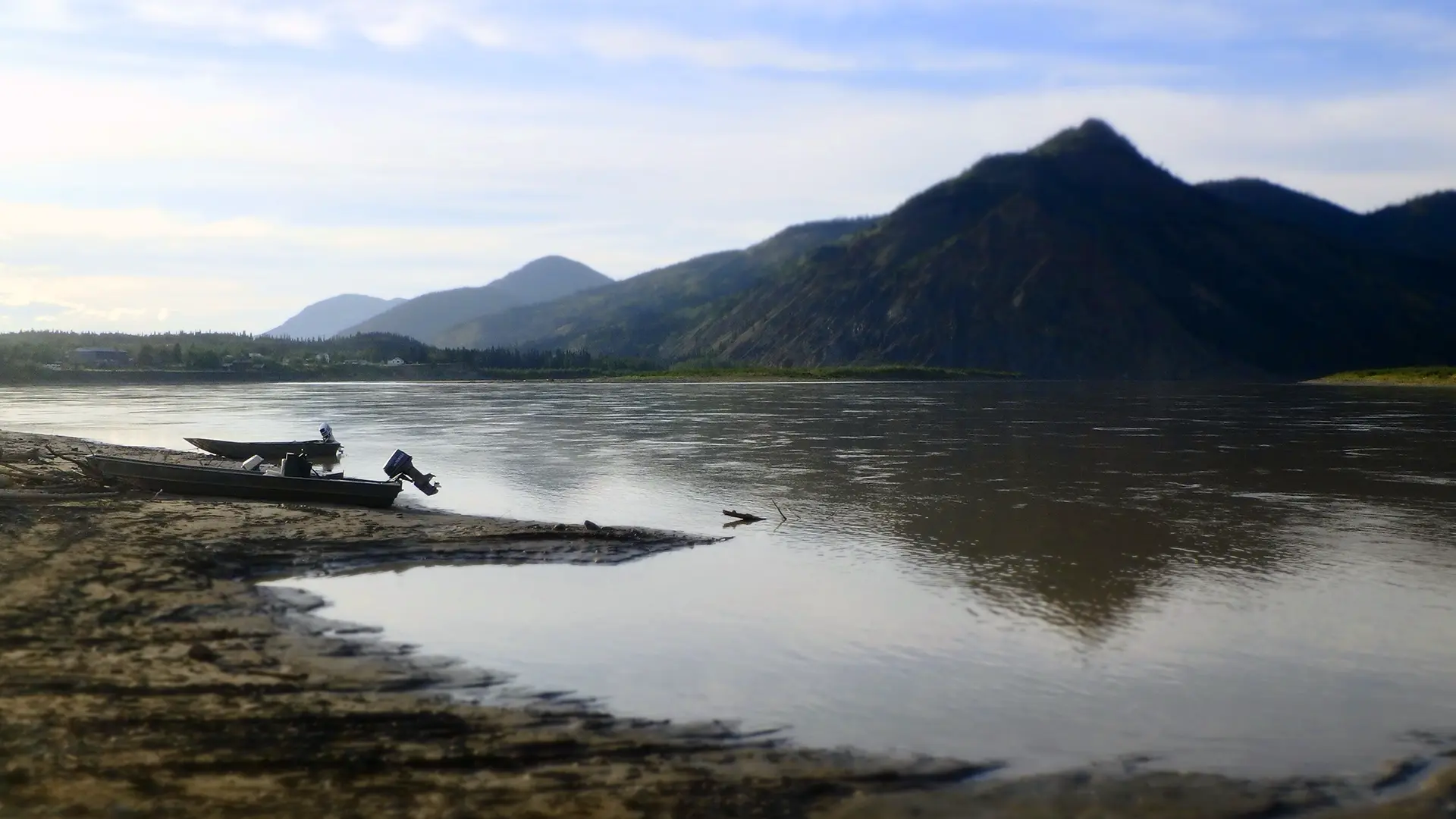 Skiffs pulled out of water, across from a mountain. Photo courtesy Lindsay Bothe Culverhouse.